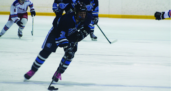James Wilder (3) cuts to the middle and moves the puck into the offensive zone. Photos by Mike Flanagan