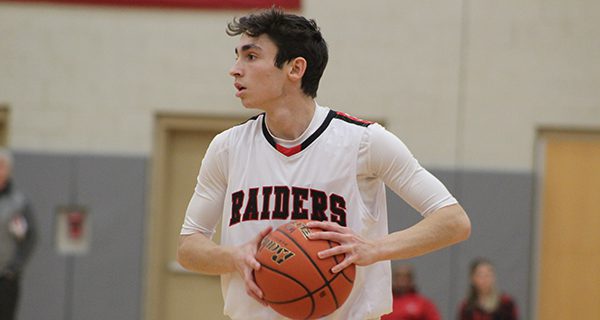 Senior guard Mark Harrington (pictured) works the ball around the perimeter. Photos by Michael Flanagan