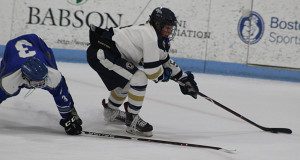 Senior captain and forward Tom Chmielewski utilizes his size and powers his away to the net for a scoring opportunity.