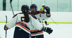 Emily Desimone (8) celebrates her would-be game winning shorthanded goal with teammate Meghan Hamilton (C) on Monday night.