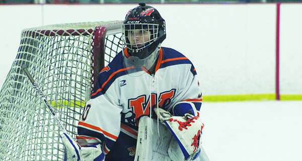Senior goalie Kiera McInerney (pictured) hugs the post and keeps an eye on the puck down in the corner.
