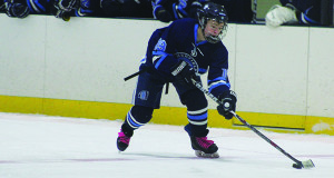 Senior forward Justin Fuglestad (19) moves the puck through the neutral zone.