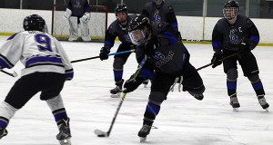 Sophomore forward George Herlihy (3) fires a shot on net during a rush up the far-side boards.