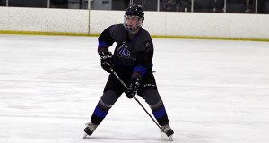 Sophomore defenseman Billy Rooney (pictured) holds the puck in at the blue line and gets set to fire a shot on cage.
