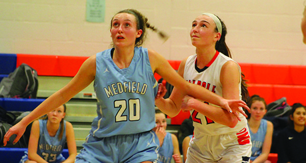 Medfield’s Camilla Silk (20) and Walpole’s Jill White (21) battle for positioning on a fourth quarter rebound. Photos by Michael Flanagan