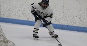 Junior forward Celia Blaszkowski (pictured) operates the puck behind the Weymouth net during the Needham girls 9-1 victory against the Wildcats on Saturday.