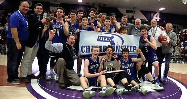 The DS boys pose together with their state championship banner following Saturday’s 71-56 win over Bishop Stang in the Division III finals.
