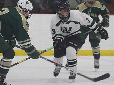Senior forward Matt Hetnik (3) eyes his prey before delivering an open-ice hit. Photos by Michael Flanagan