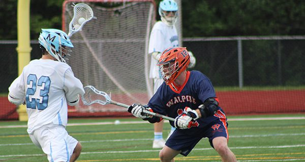 Walpole’s Ethan Kelley (12) defends against Medfield’s Brian Abely (23) midway through the second quarter. Photos by Mike Flanagan