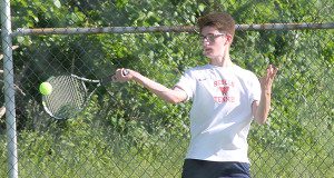 Freshman Jake Lowenstein handles a high forehand during a long baseline rally. Photos by James Kinneen