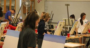 Students in ‘Painting With Purpose’ work on the paintings they will give to someone that needs a morale boost. Photos by James Kinneen