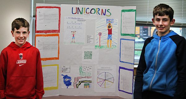 Two students stand in front of “Unicorns” the exercise committed civilization designed to stem obesity rates.