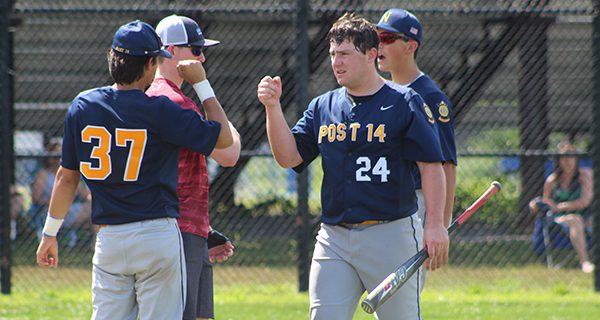 Matt Connelly (24) is congratulated by Andrew Ko (37) after scoring Needham Post 14’s first run of the game against Hyde Park on Sunday.