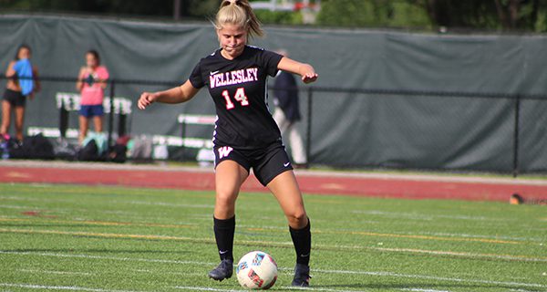 Sophomore midfielder Catherine Smith (14) moves the ball up the field early in the first half. Photos by Mike Flanagan