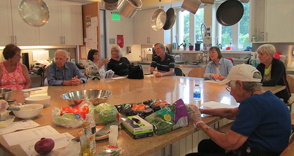 The crowd discusses some of its favorite recipes and burger combinations during CATH’s cooking demonstration with Director of Aging Services LaTanya Steele.