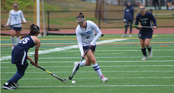 Senior captain Sydney Scales (15) moves the ball up the field during her four-point performance against Framingham on Thursday.