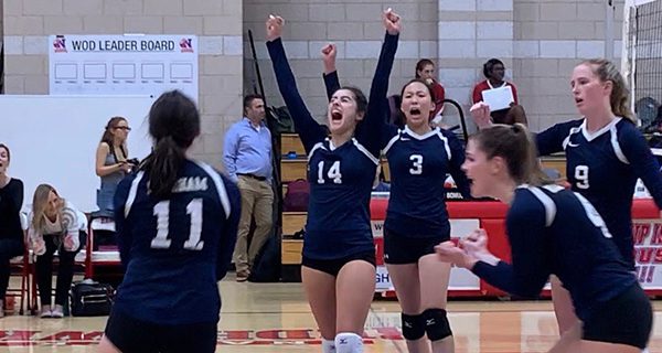 Needham’s Albina Miloshi (#14), Karen Nie (#3), Sarah Jensen (#9), Daly Johnson (#4), and Olivia Kierstead (#11) celebrate after defeating Natick in the third set, leading them to an eventual 4-1 victory to add to their undefeated record.