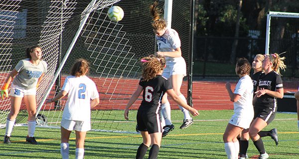 Cerys Balmer rises and clears a Wellesley corner with her head to keep the Wellesley Raiders scoreless.