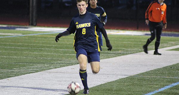 Senior midfielder/forward Adam Driscoll (8) moves the ball up the field late in the first half. Photos by Mike Flanagan