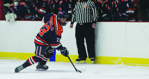 Junior forward Ethan McDonough (22) cuts to his backhand and moves the puck up the ice through the neutral zone.