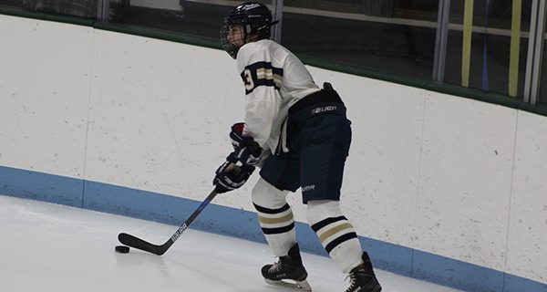 Junior forward Grace Kelley (3) navigates the puck down low and feeds a pass out front during a second period power play.