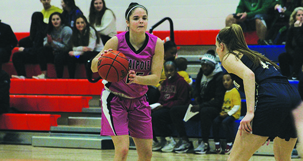 Pictured while moving the ball around the perimeter, Walpole High senior captain and point guard Sydney Scales (15) joined the 1000-point club on Thursday night during the Rebels’ home contest against Foxboro.